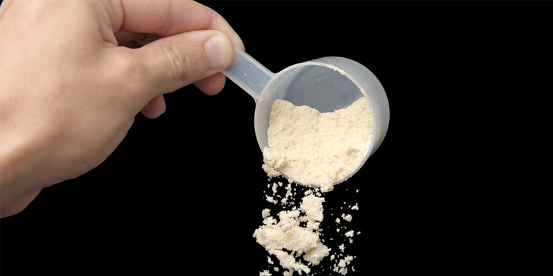 scoop of freeze dried breastmilk pouring down