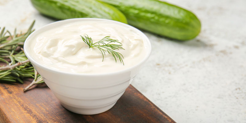 bowl of sour cream with cucumbers