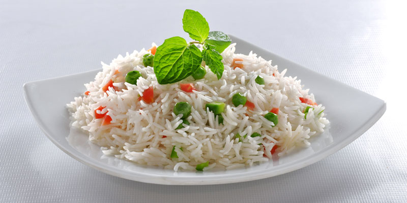 plate of rice with carrots and peas. 
