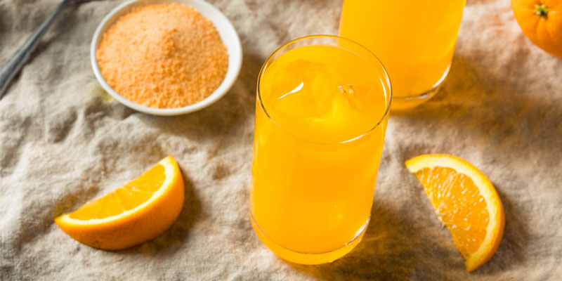 glasses of orange juice with orange slices 