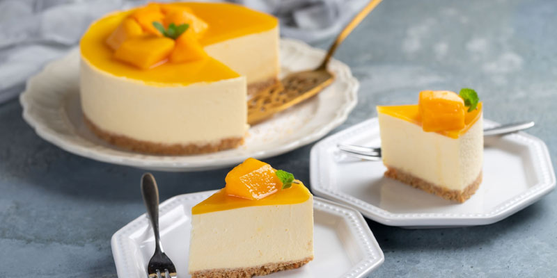 slices of mango cheese cake on little serving plates. 