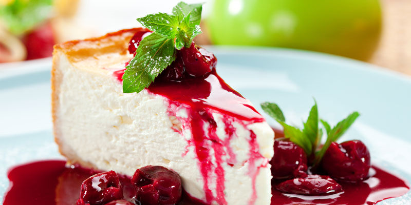 cheese cake with oozing, dark red raspberry topping