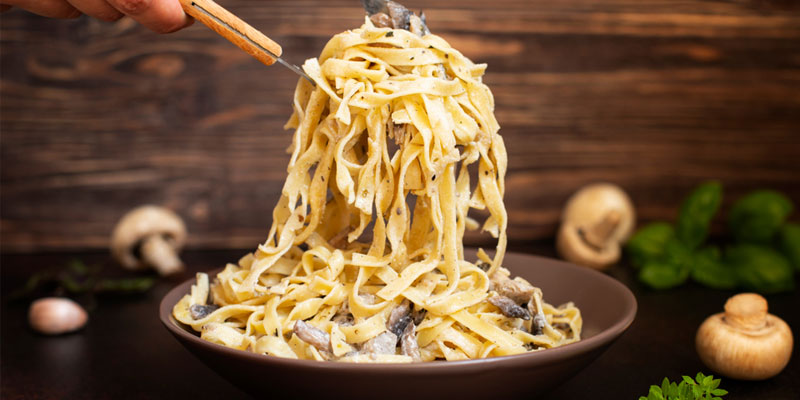 pasta in creamy mushroom sauce on a bowl. 
